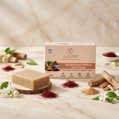 ILIKAM sandalwood and saffron Glow Bath Bar box beside a handmade soap bar